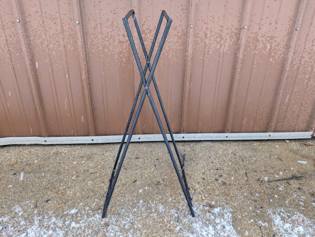 The bare steel frame standing against a barn wall